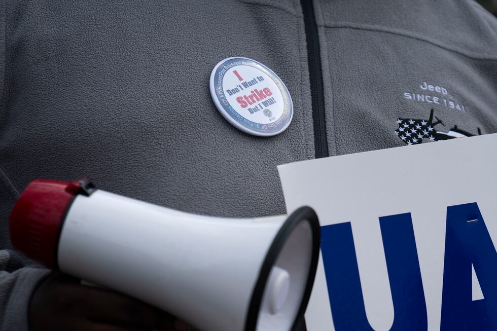 FILE - Eric Thomas, who works at the Belvidere Assembly Plant, pickets with other members of...