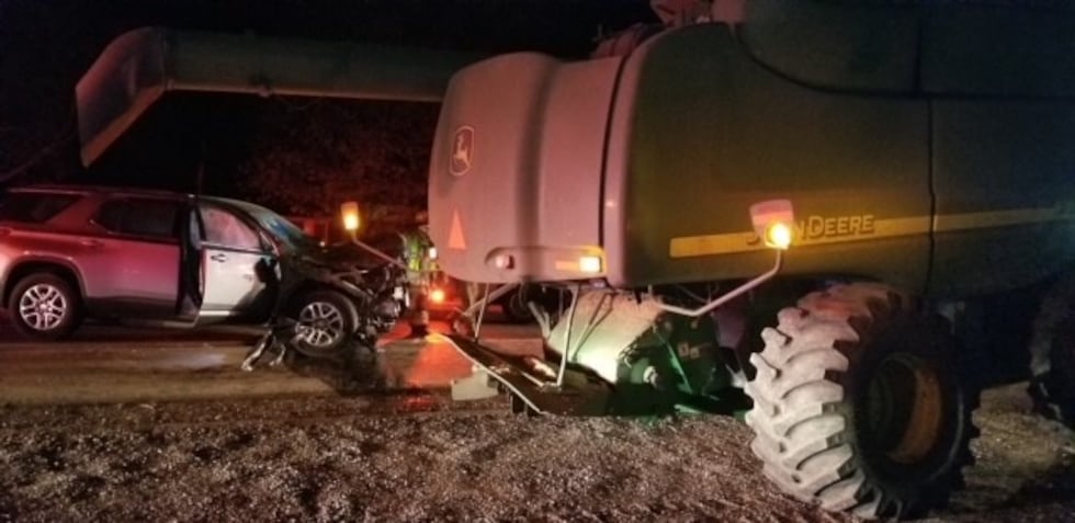 A woman has died after the driver of the car she was in struck a John Deere tractor on...