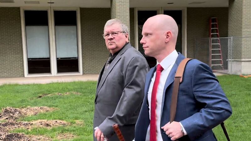 The former head of a Michigan marijuana licensing board Rick Johnson, left, walks with his...