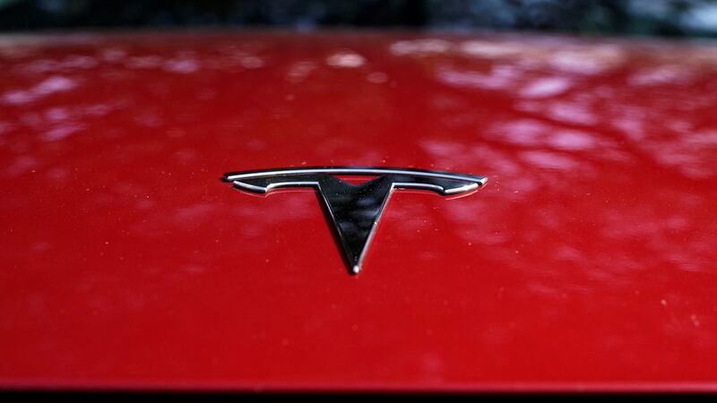 A Tesla logo is seen on a vehicle on display in Austin, Texas, Wednesday, Feb. 22, 2023. On...
