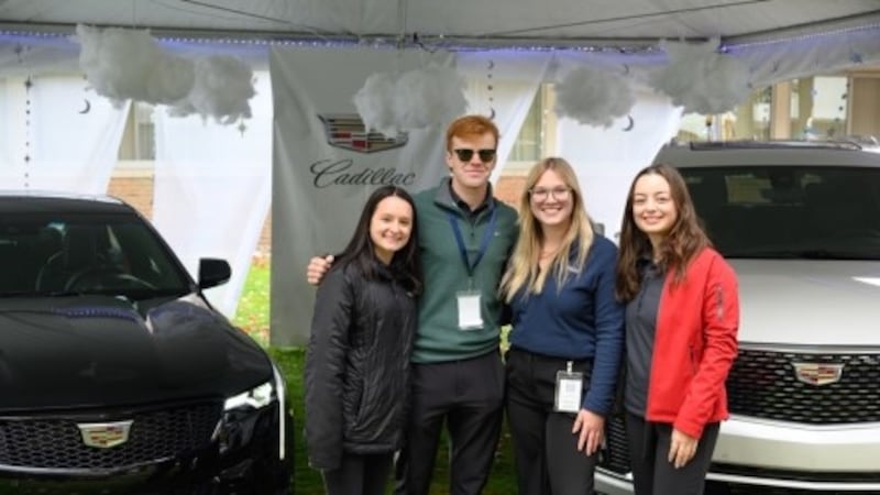 Northwood University students are pictured by the Cadillac display at the 2022 Northwood...
