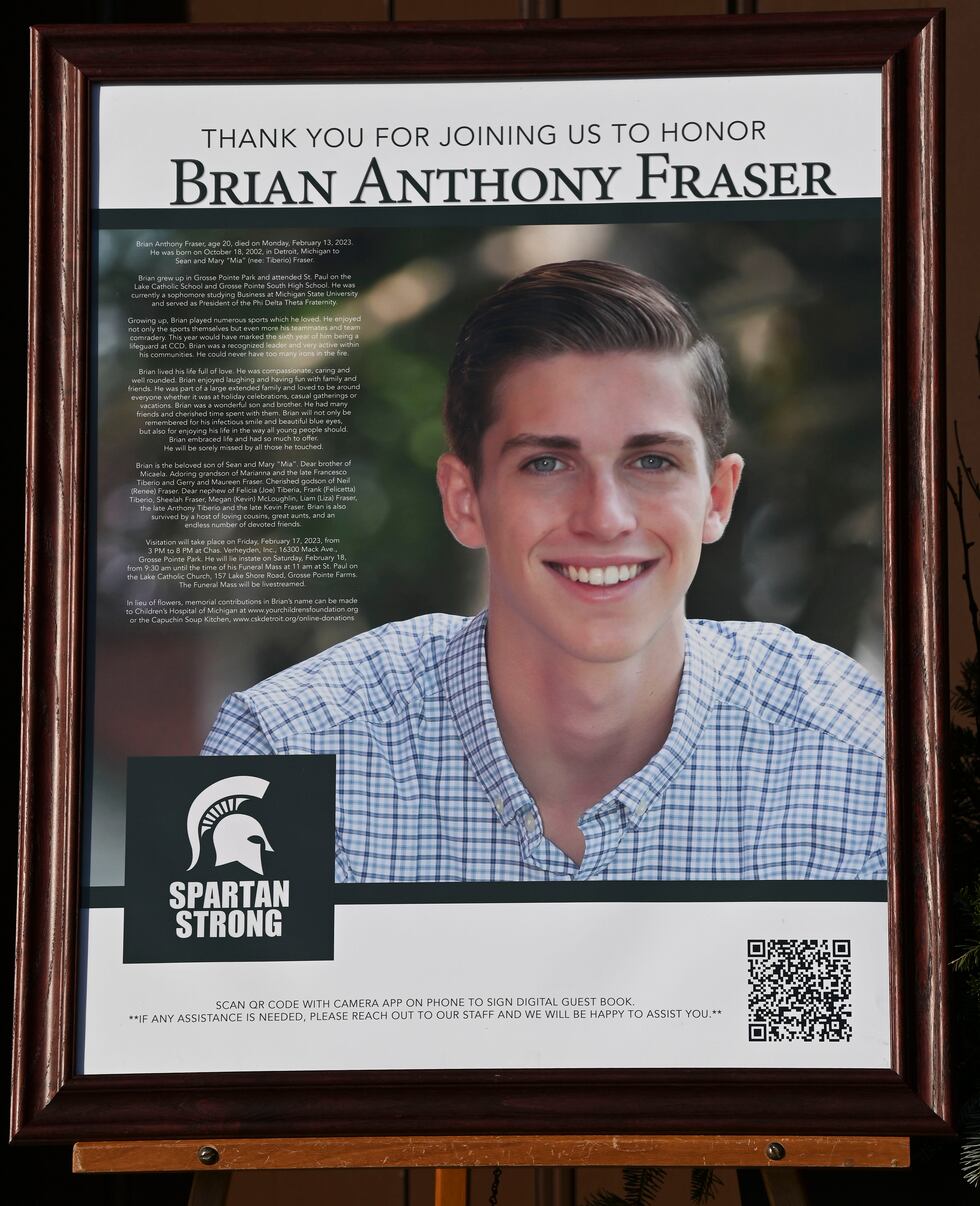 A poster of Brian Anthony Fraser is displayed outside the church as family members friends and...