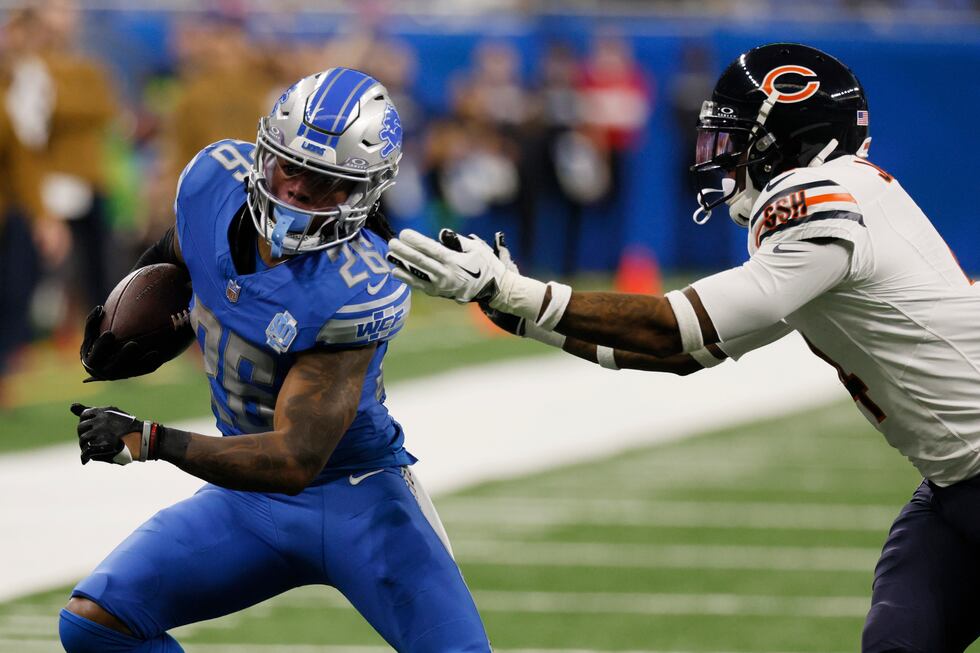 Detroit Lions running back Jahmyr Gibbs pulls away from Chicago Bears safety Eddie Jackson...