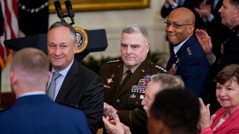 Chairman of the Joint Chiefs of Staff Gen. Mark Milley, center, second gentleman Doug Emhoff,...